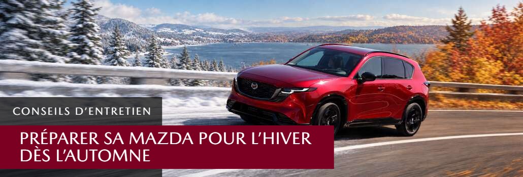 Préparer sa Mazda pour l'hiver : VUS Mazda rouge sur une route enneigée bordée d'arbres d'automne